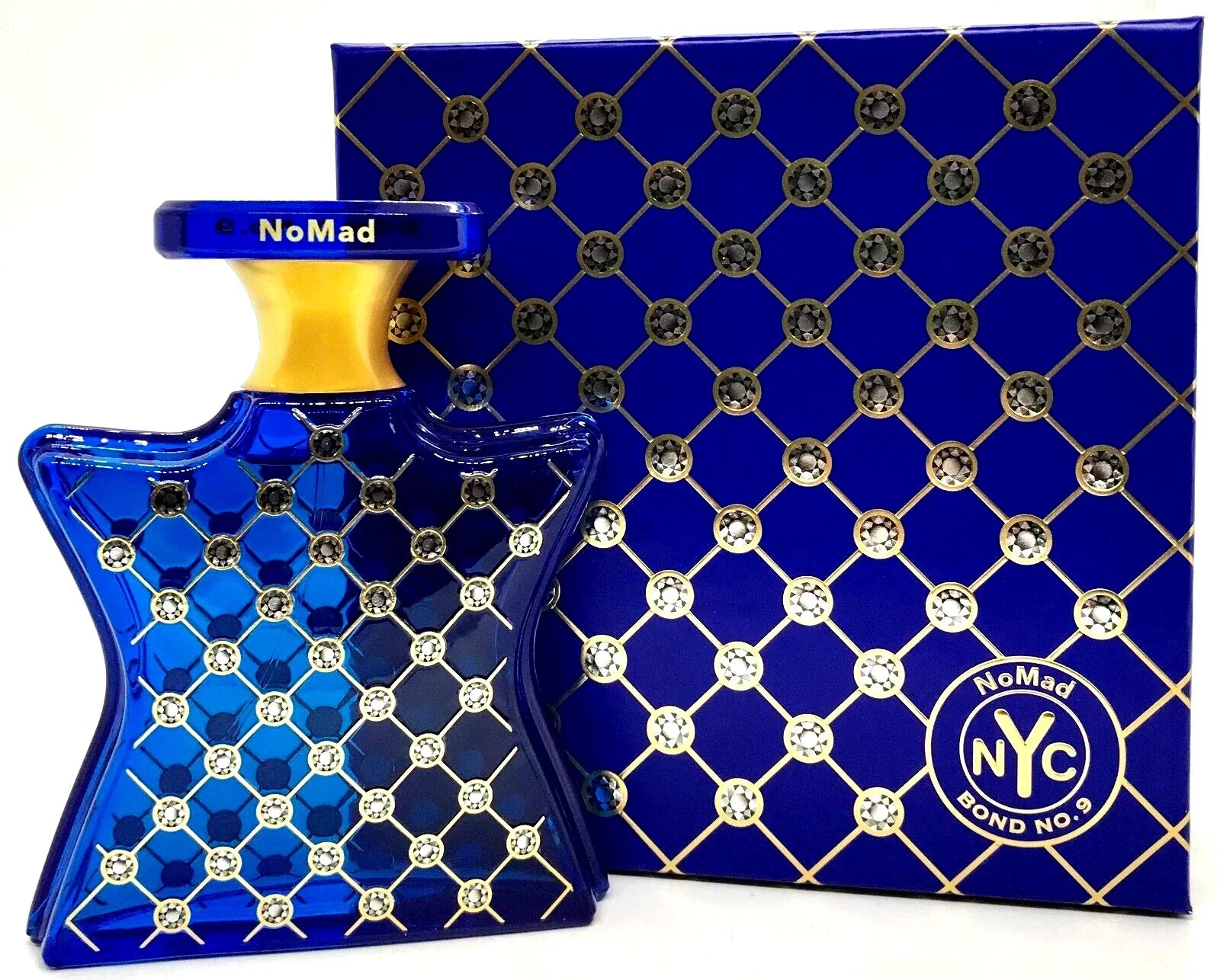 Blue and gold perfume bottle with matching box featuring 'NoMad NYC' branding.